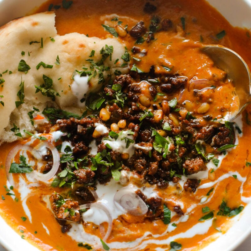 Carrot soup with ground beef topping.